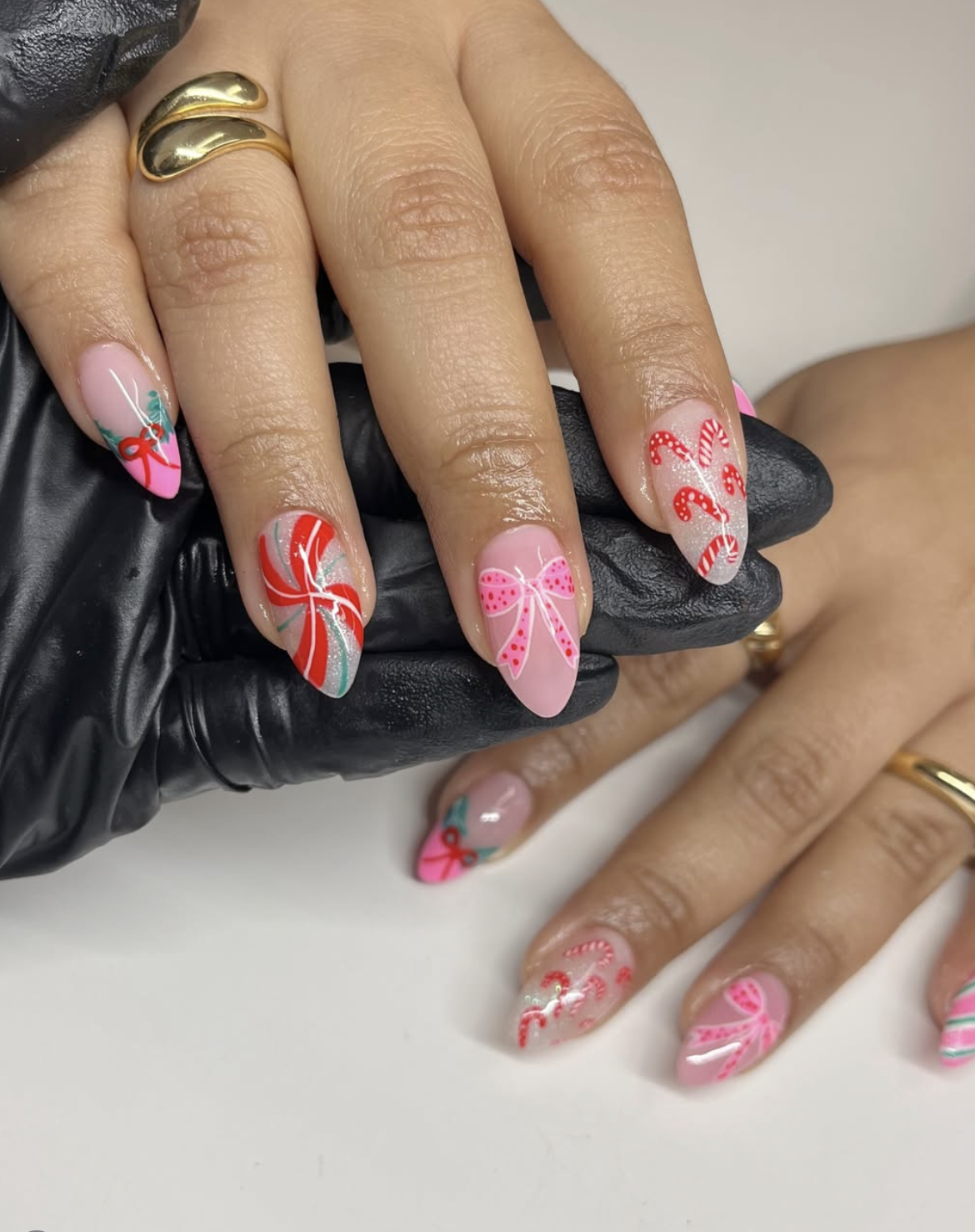 Pink and white candy cane nails over a sheer blush base