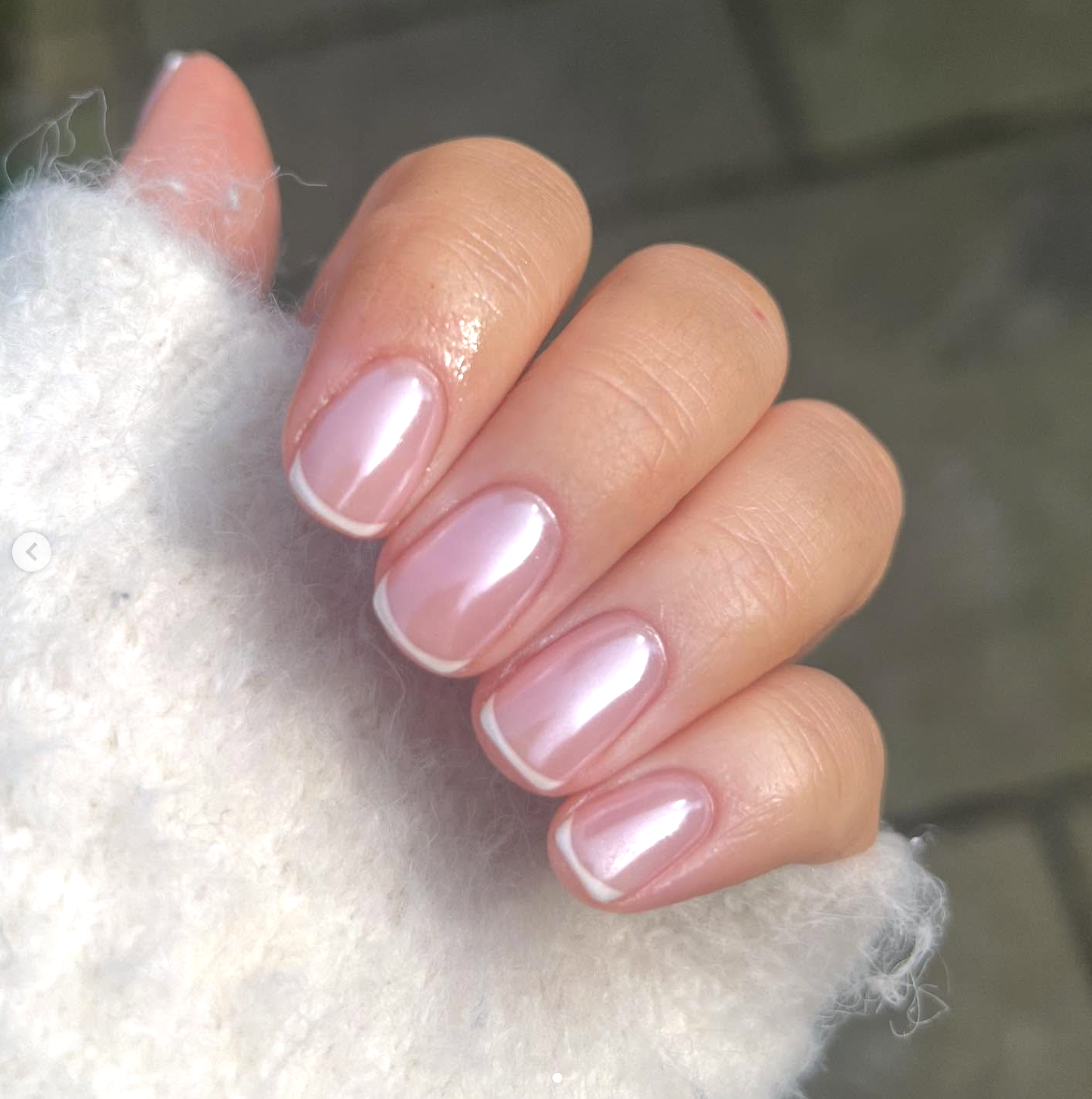 Short, rounded nails featuring a pearly glazed donut chrome finish and a clean, ultra-thin micro French tip design.