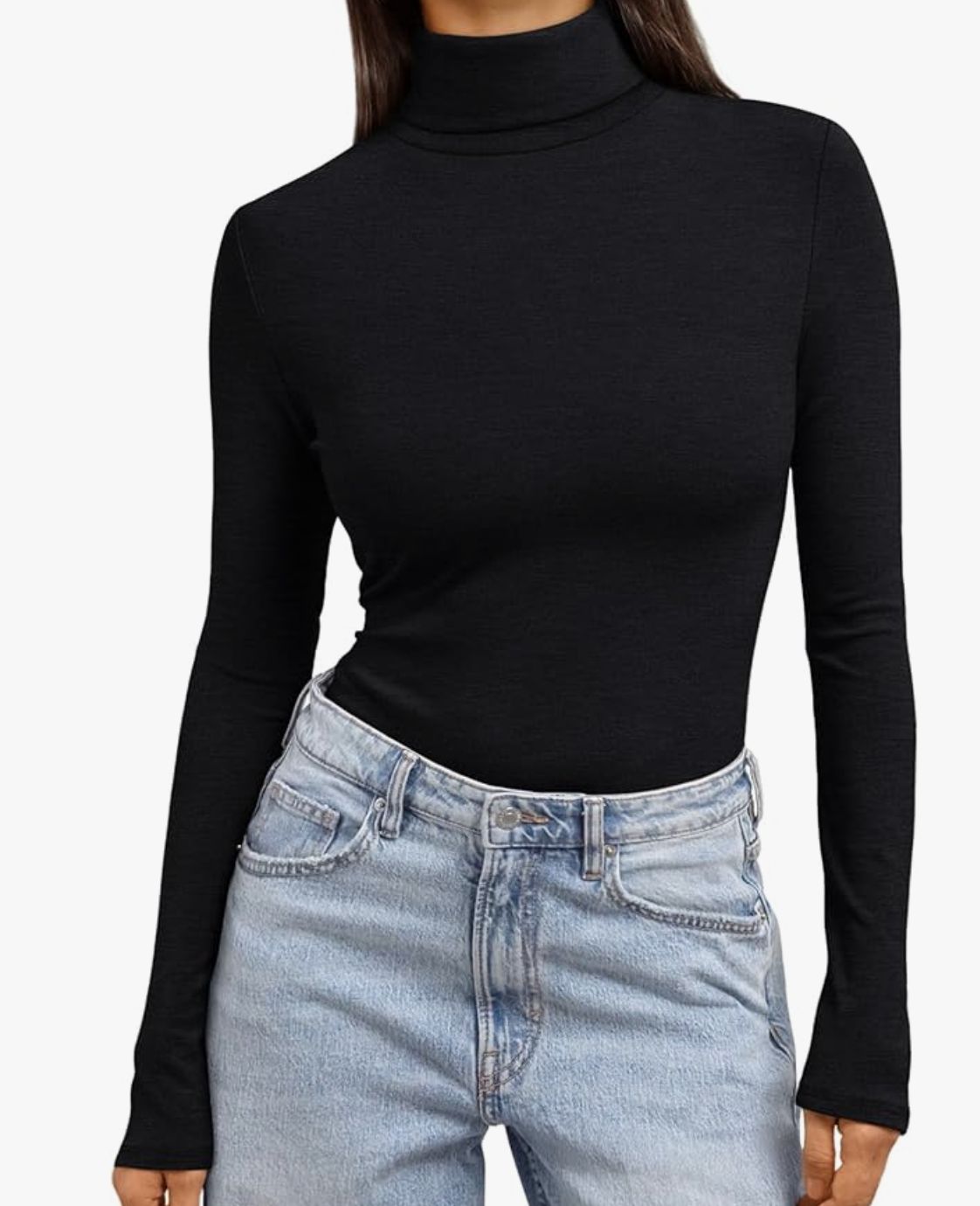 A studio product shot of a woman wearing a black Turtleneck Long Sleeve top from Amazon, tucked into light-wash blue jeans.