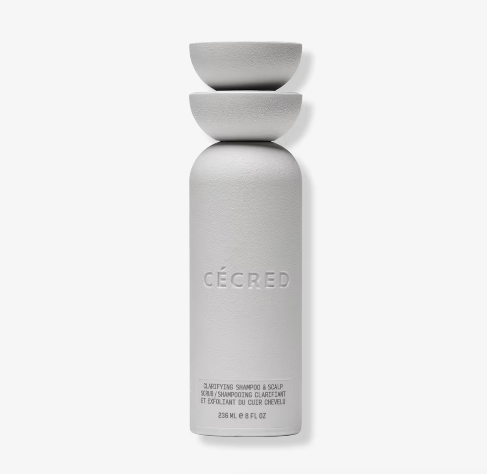A bottle of Cécred Clarifying Shampoo & Scalp Scrub, a detoxifying treatment for product buildup and scalp health.