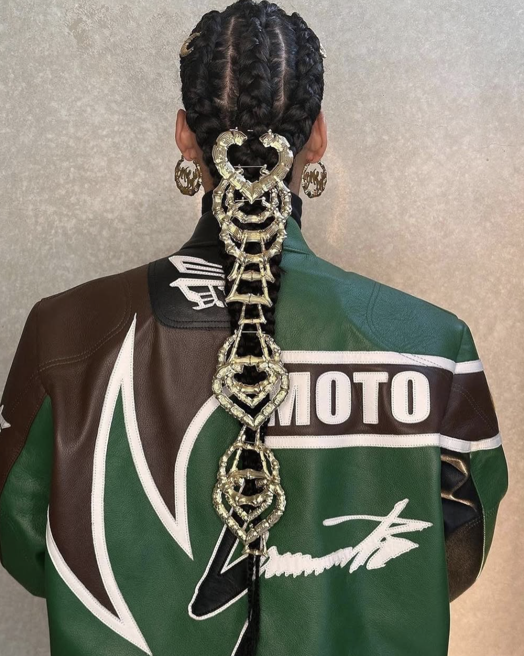 Alicia Keys featuring an architectural cornrow updo with height at the crown and intricate braided patterns, highlighting her sharp cheekbones and diamond face shape.