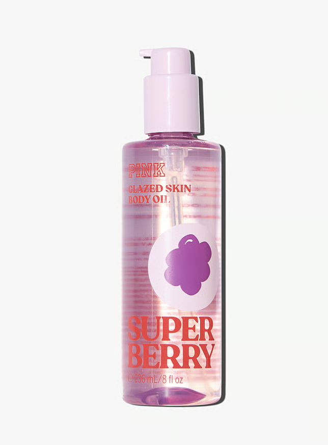 A bottle of Victoria's Secret PINK Super Berry Glazed Skin Body Oil, featuring a purple tint and a white pump dispenser on a transparent background.