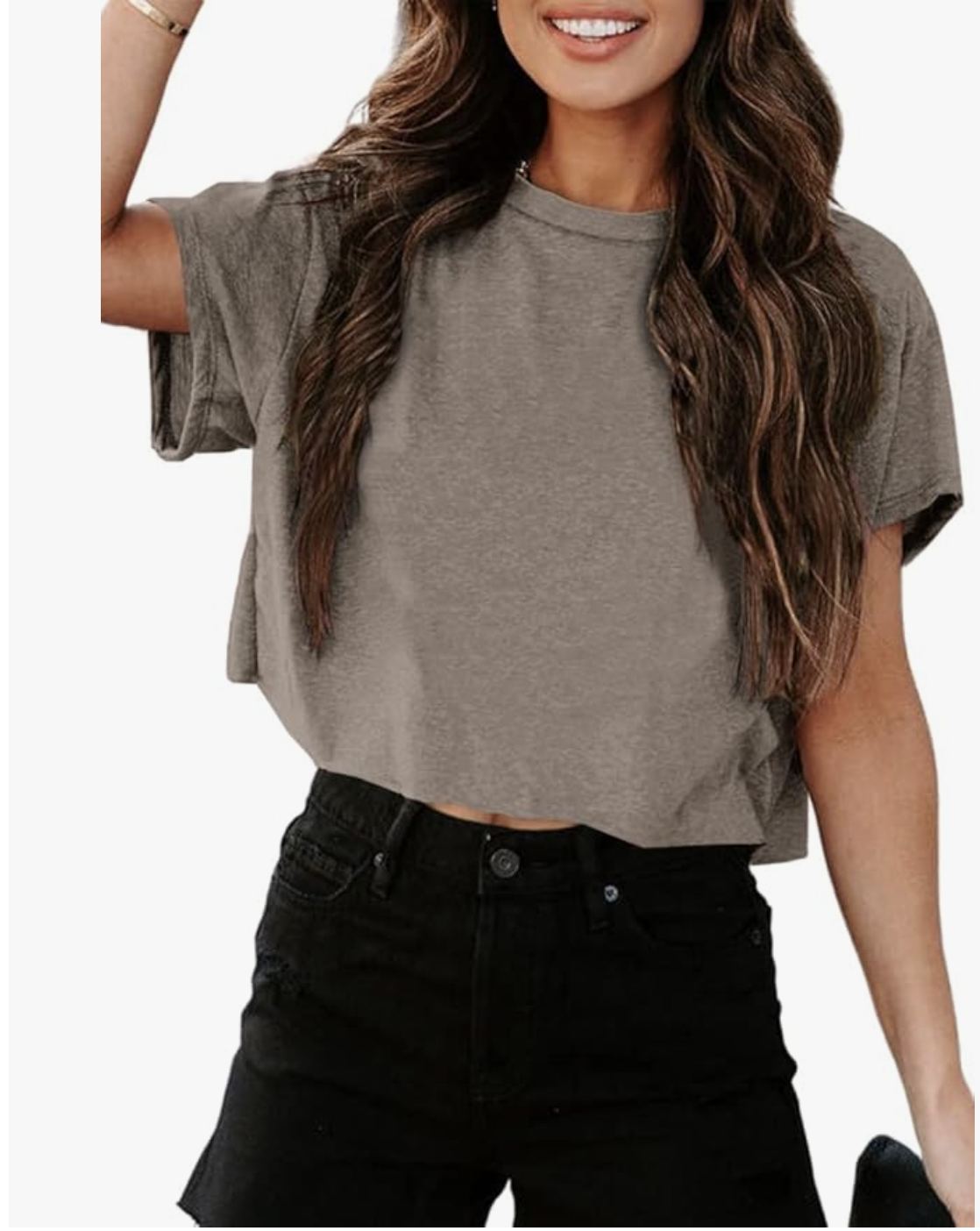 A woman wearing a grey crewneck cropped T-shirt and black denim shorts, styled for a casual summer BBQ outfit.