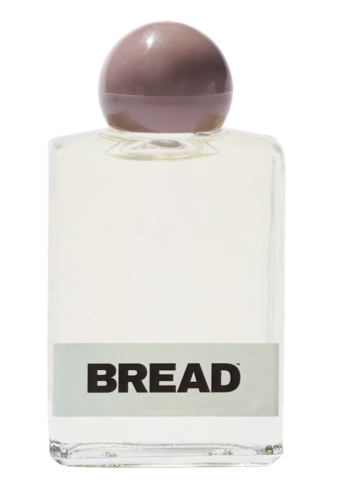 Bread Beauty Supply Hair-Oil Everyday Gloss in a clear glass bottle with a minimalist label and a purple cap, showcasing the lightweight, non-greasy oil texture for adding high-shine to curls and coils."