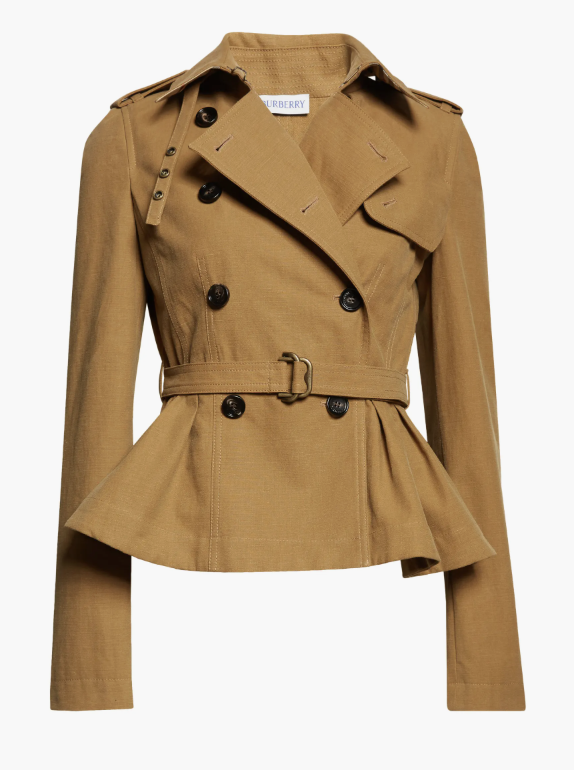 A honey-colored Burberry Isabella Peplum Trench Jacket featuring a cinched belted waist and a feminine flared peplum hem, perfect for an understated luxury look.