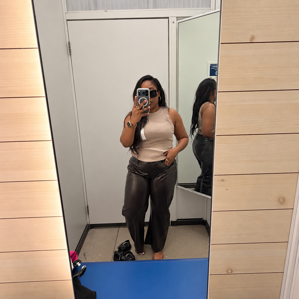 Woman in a dressing room mirror wearing Old Navy's Light Brown Ribbed Tank.