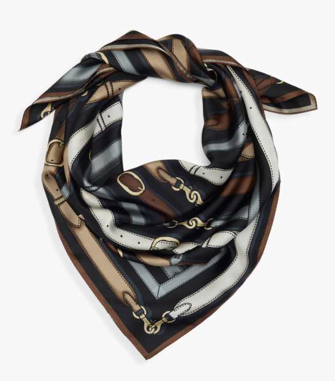 Black, cream, and brown printed silk scarf with equestrian chain detail folded on a white background.