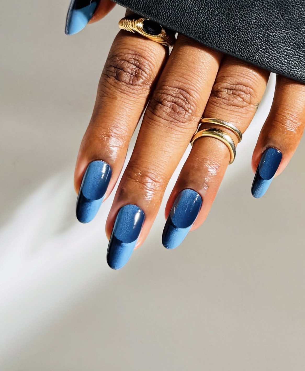Long almond-shaped nails featuring a mesmerizing deep ocean blue cat-eye polish with a luminous velvet shimmer, showcasing cute June nail ideas.