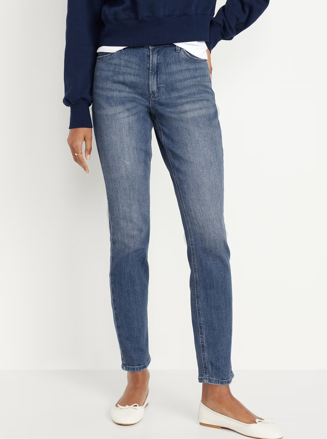 Woman wearing Old Navy Wow high-waisted straight ankle jeans with a clean fit through the waist and legs.