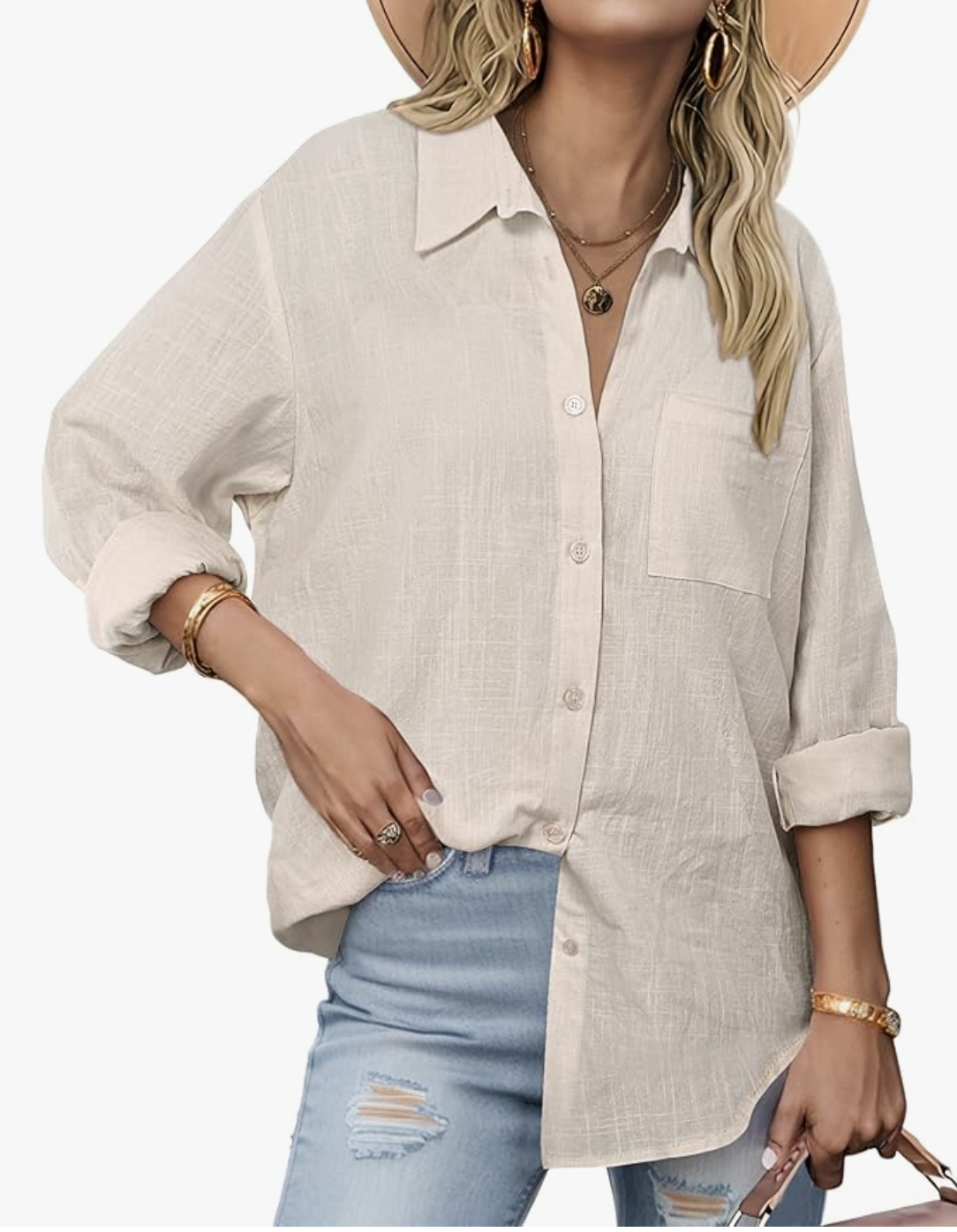 A woman wearing a beige long-sleeve cotton gauze button-down shirt with a relaxed fit, styled over denim shorts for a summer BBQ outfit.