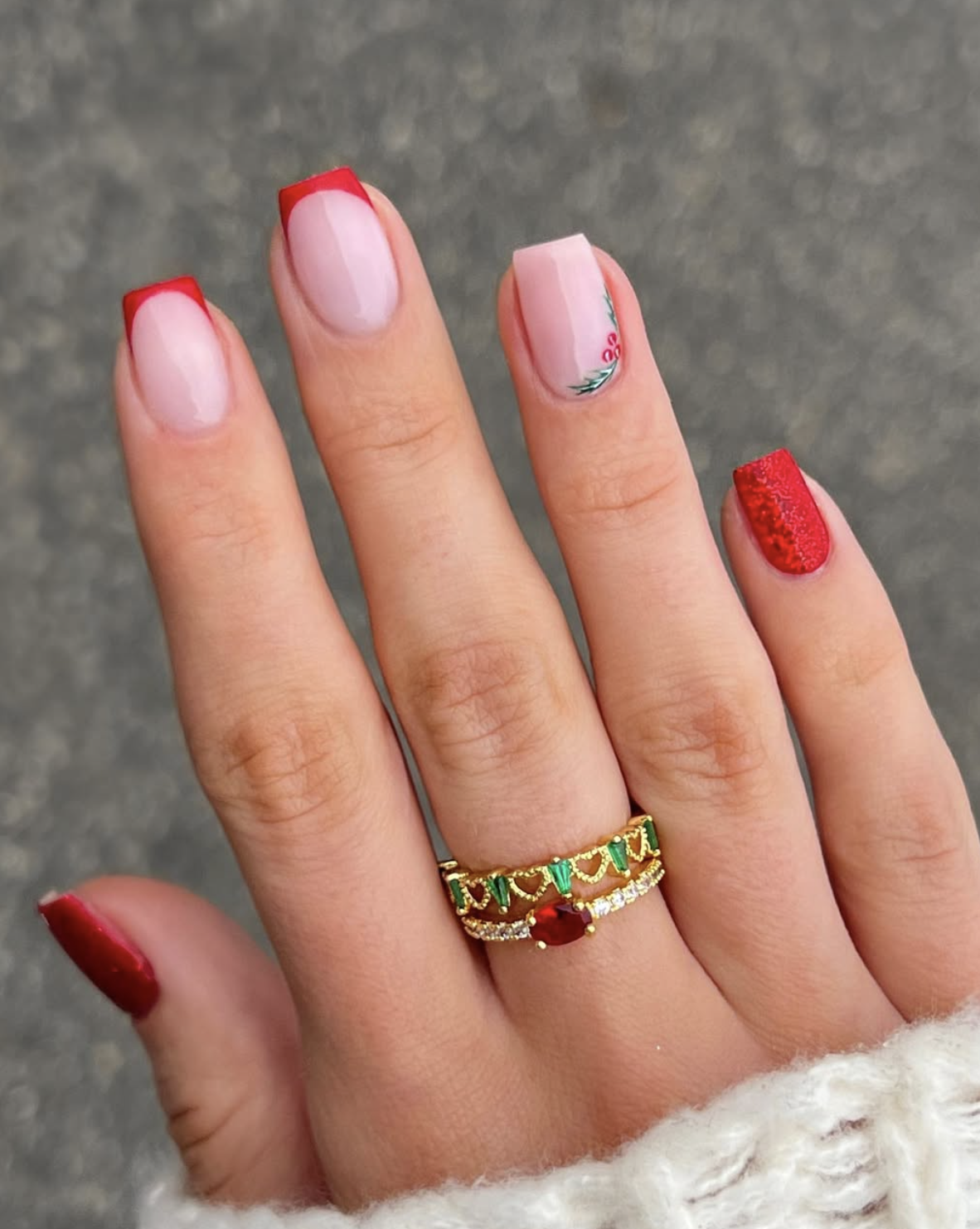 Minimal Christmas nails with a tiny holly accent on a sheer nude base