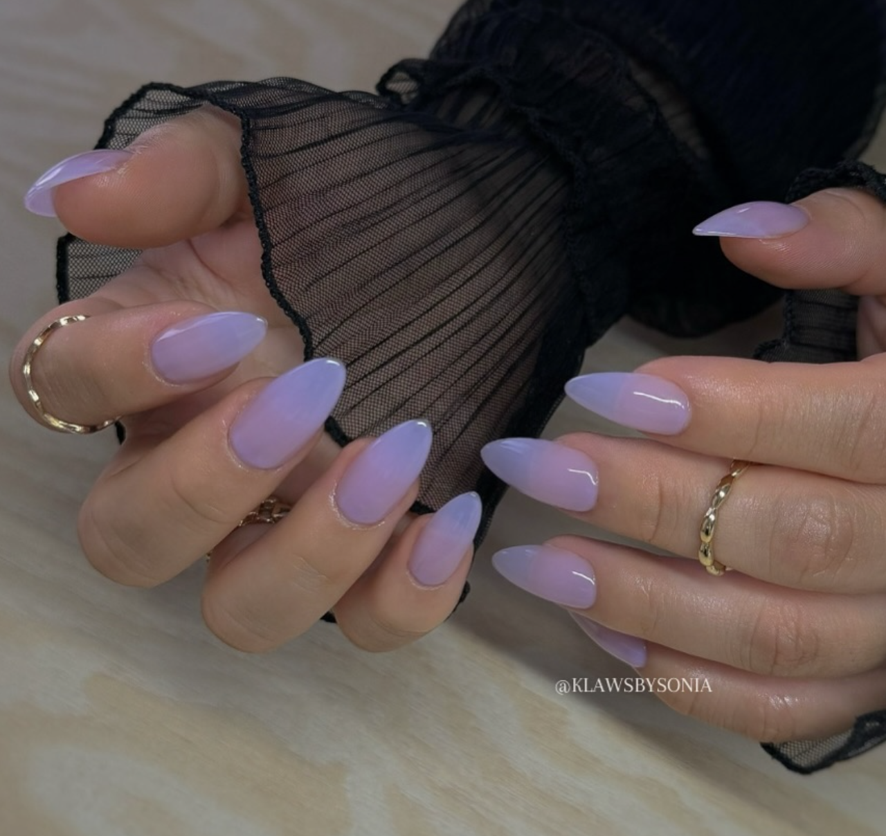 Long almond-shaped nails featuring a sheer lavender aura design that fades softly into a translucent lilac tip, showcasing cute June nail ideas.