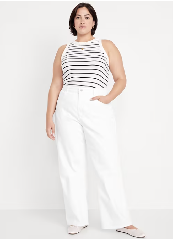 Woman wearing Old Navy extra high-waisted white wide-leg jeans designed for a thick waist and narrow hip silhouette.