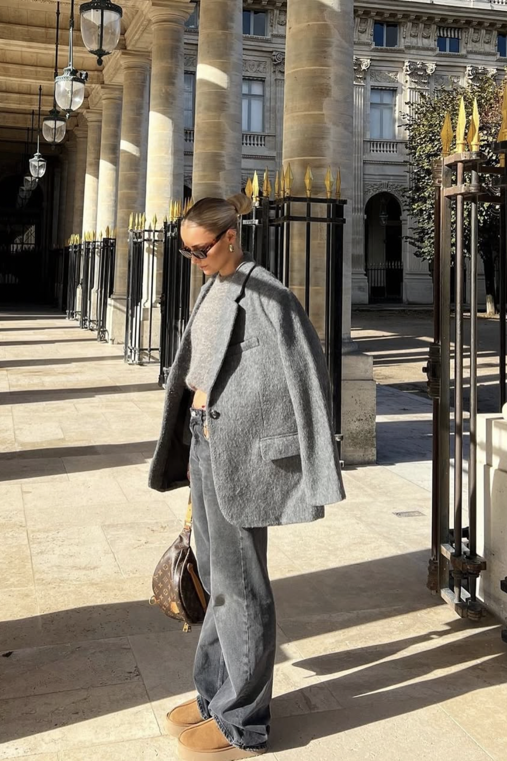Gray coat and knit with relaxed gray jeans and chestnut platform shoes.