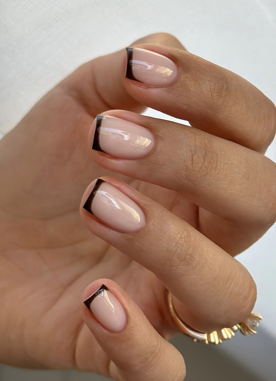 Close-up of short rust french on neatly manicured hands