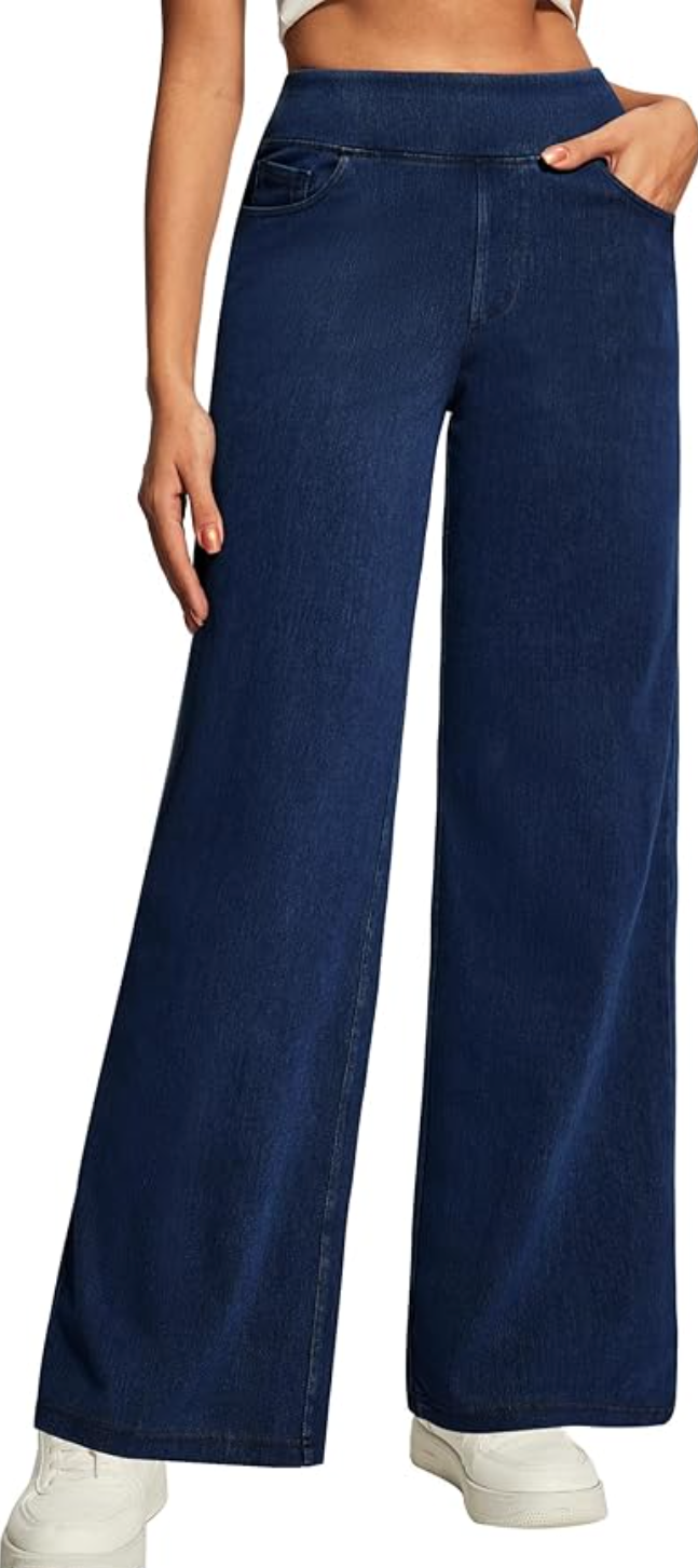 A close-up of a person wearing dark blue wide-leg jeans from Amazon with a stretchy paperbag waistband, styled with white platform sneakers.