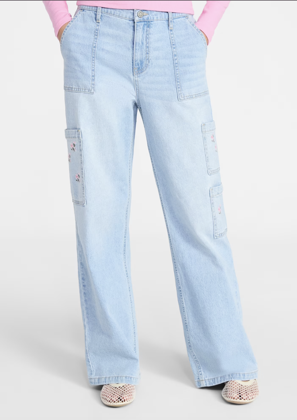A pair of light-wash wide-leg cargo jeans featuring side pockets, styled with cream mesh ballet flats for a modern utility look.