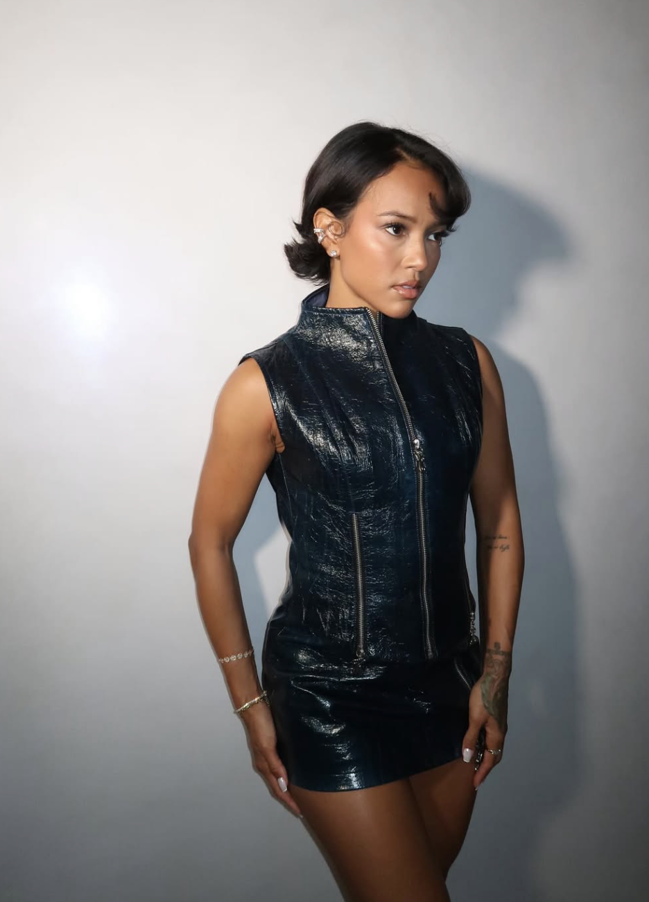 Karrueche Tran wearing a sleek, chin-length asymmetric bob with a deep side part and tucked ends to complement an oval face shape.