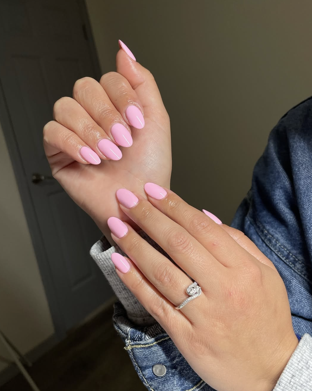 Long almond shaped nails with a solid, high-shine bubblegum pink polish.