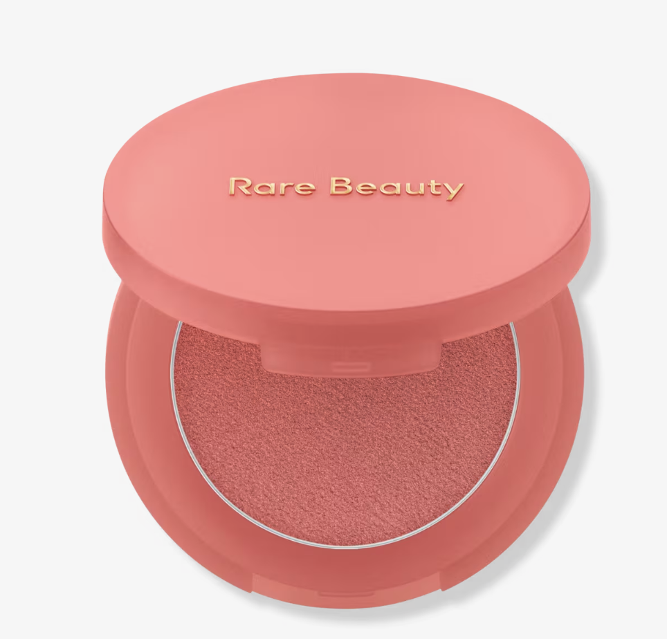 Rare Beauty Soft Pinch Matte Bouncy Blush in a circular coral-toned compact shown open to reveal the cream-to-powder formula.