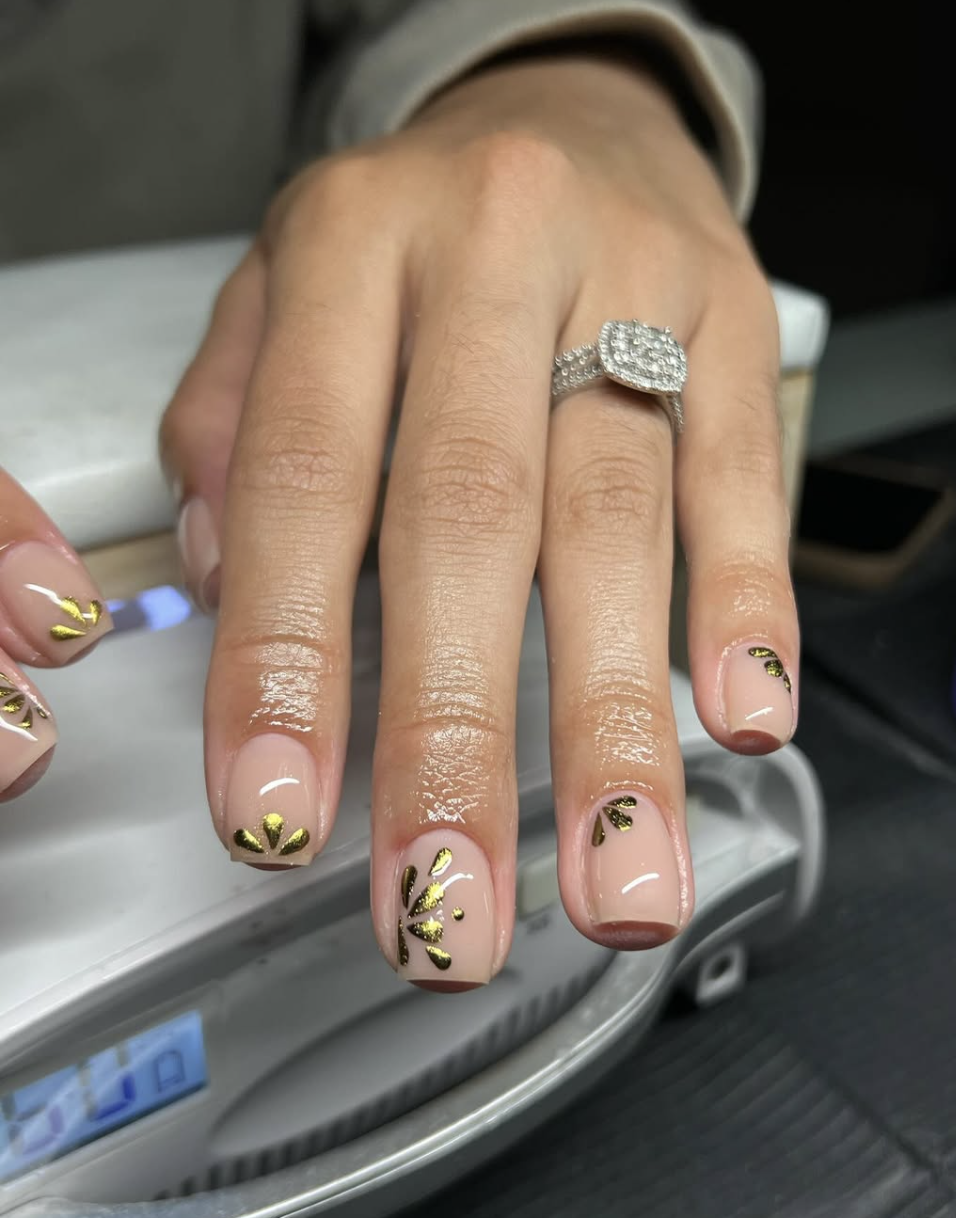 September nail idea featuring gold-leaf neutral nails