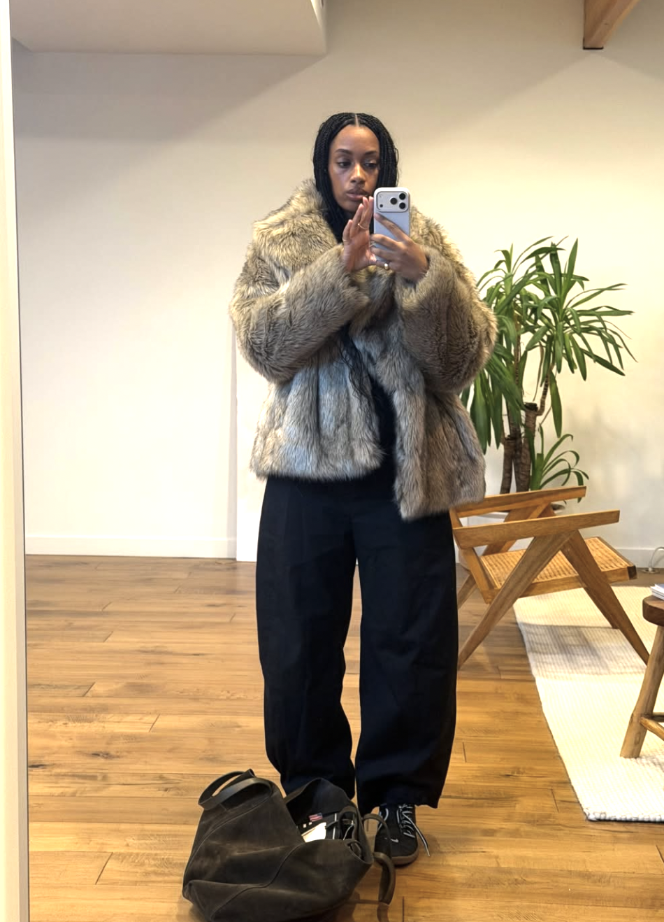 girl posing taking a selfie in front of a mirror