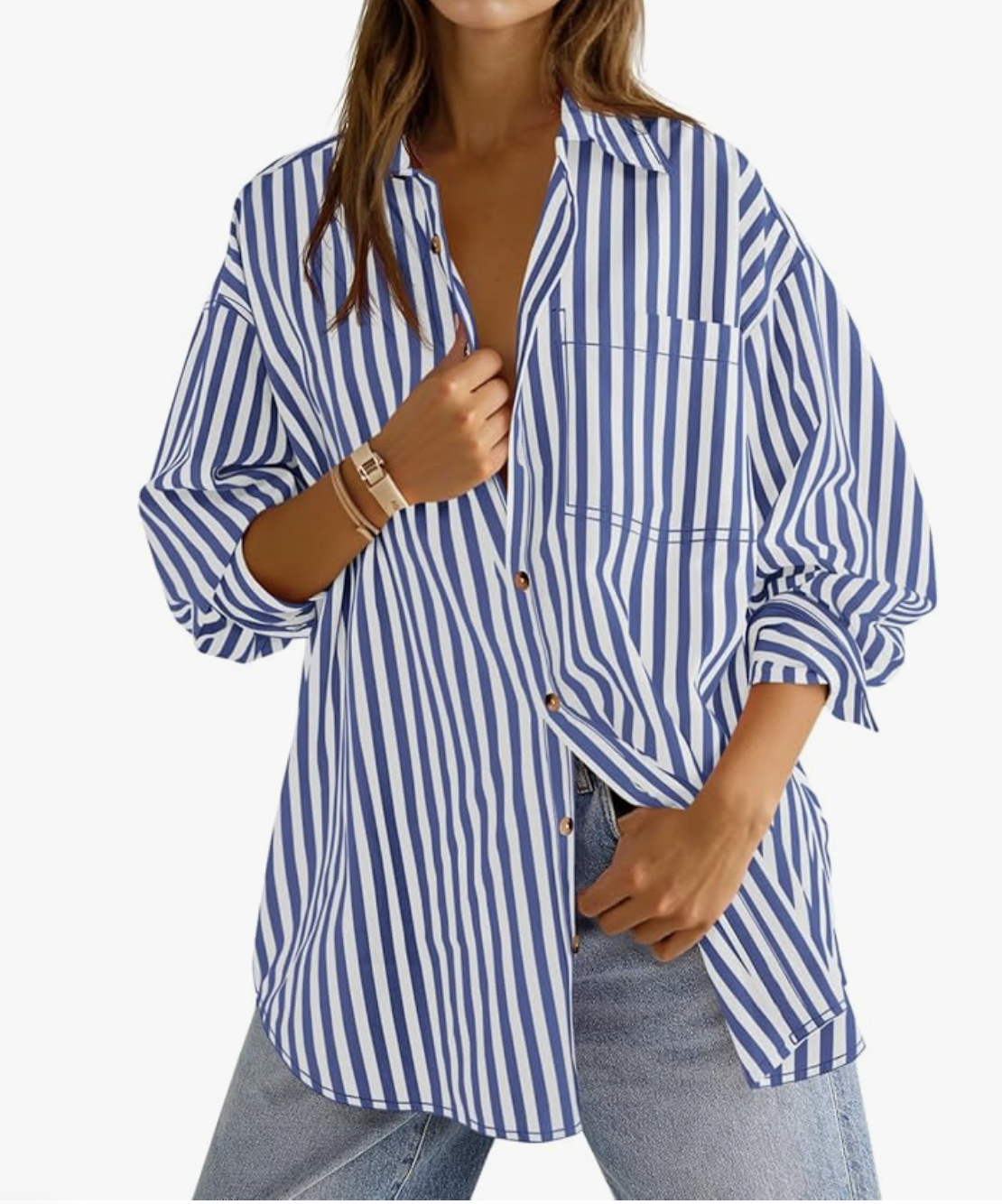 A woman wearing an oversized blue and white vertical striped button-down shirt tucked into light wash jeans, showing a casual styling idea for everyday outfits.