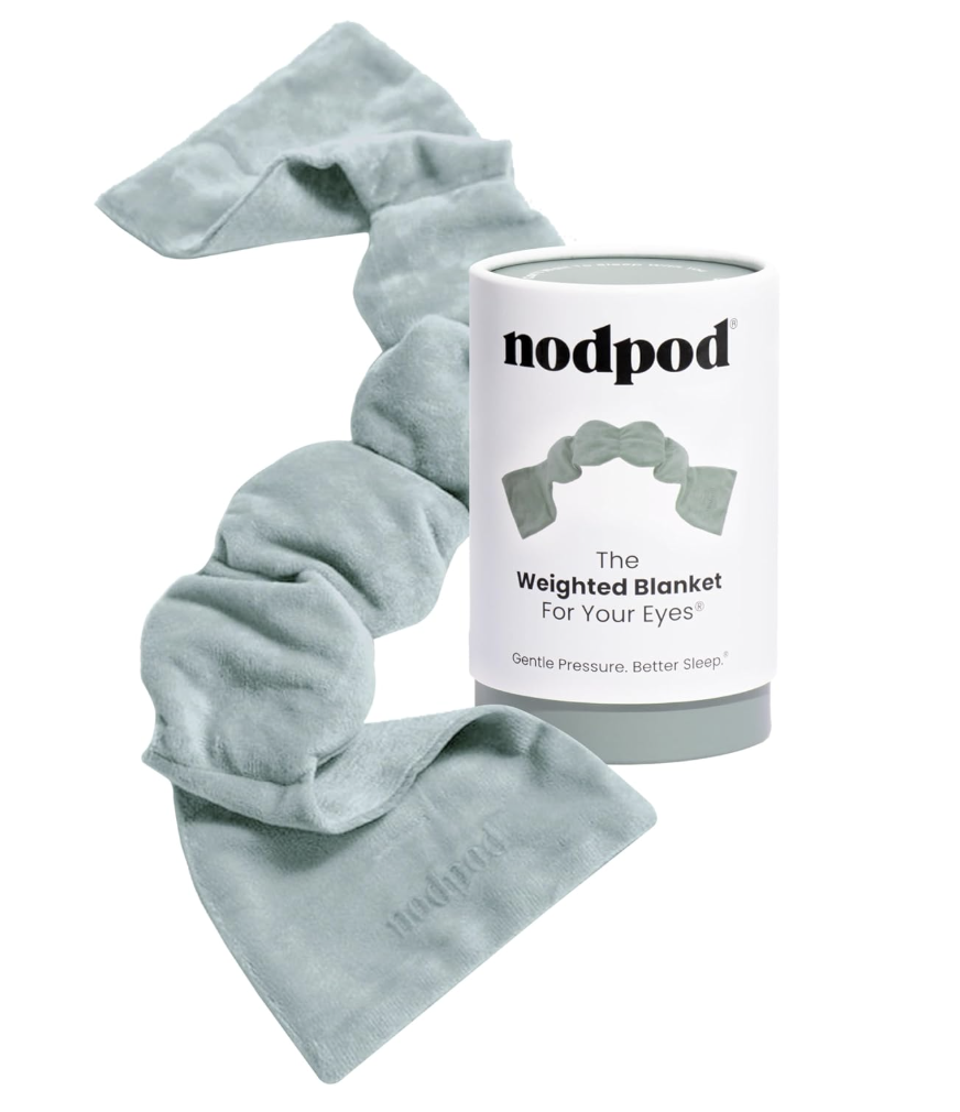 Nodpod weighted sleep mask in sage green displayed next to its cylindrical packaging.