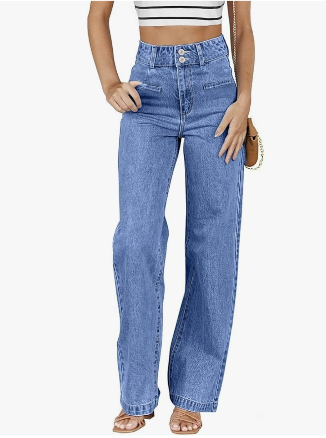 A close-up of a pair of Amazon high-waisted straight-leg jeans in a light-wash denim, styled with tan strappy sandals for a clean, fashion editor-inspired look.
