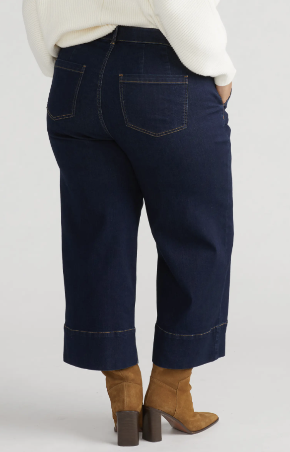 Woman wearing Universal Standard Carol high-waist crop jeans in dark indigo for a petite plus-size fit.