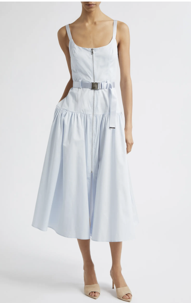 Close-up of a light blue sleeveless midi dress featuring a structured front zipper detail and a matching fabric belt with a silver buckle at the waist.