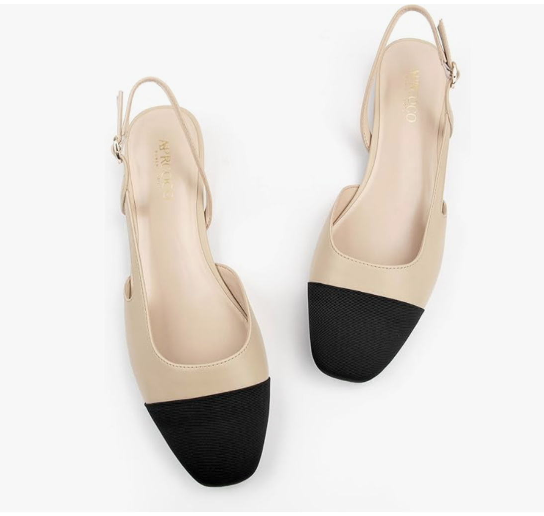A pair of beige and black two-toned slingback flats featuring a square cap-toe, a dainty ankle strap with a gold buckle, and a minimalist flat sole.