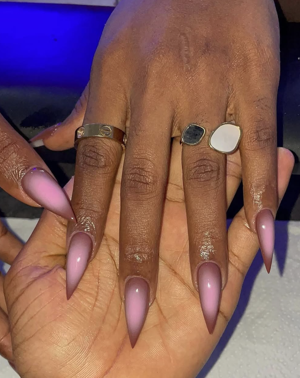 Five nails painted in a progression of muted rose, pink-brown and chocolate shades.