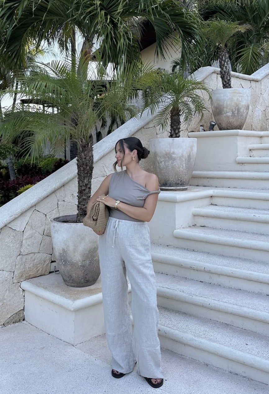 A pair of cream and tan platform espadrilles by Free People with a textured woven toe, tan leather straps, and a thick black and white foam sole.