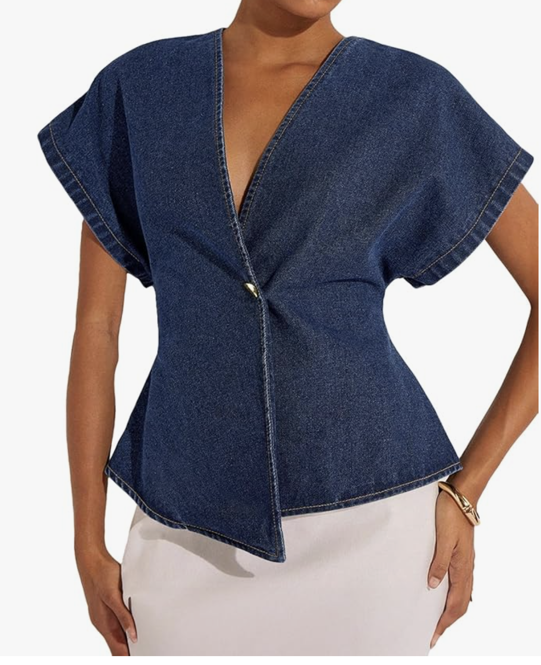 A dark wash short-sleeve denim wrap top with a v-neckline and asymmetrical hem, styled as part of a double denim outfit.