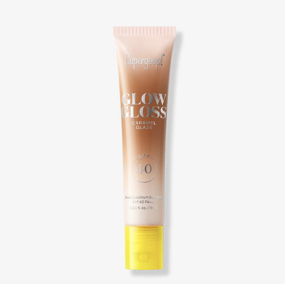 Supergoop! Glow Gloss SPF 40 Lip Balm in a sunset-gradient squeeze tube with a yellow cap.