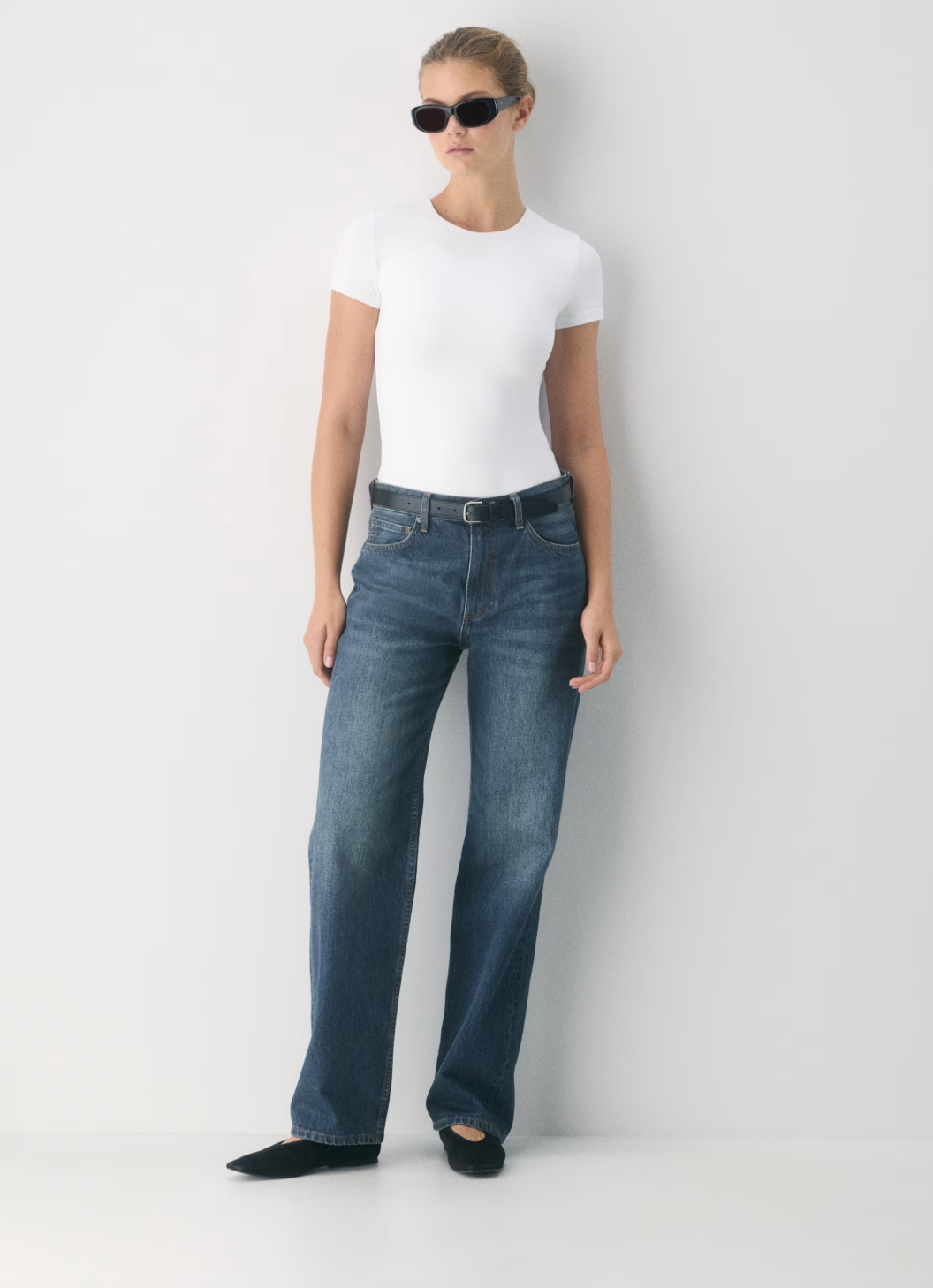 Professional traveler's pick: the Aritzia Original Contour Marvel T-Shirt in white, featuring a high-neck silhouette and double-layered boutique fabric for a smooth, wrinkle-free look.