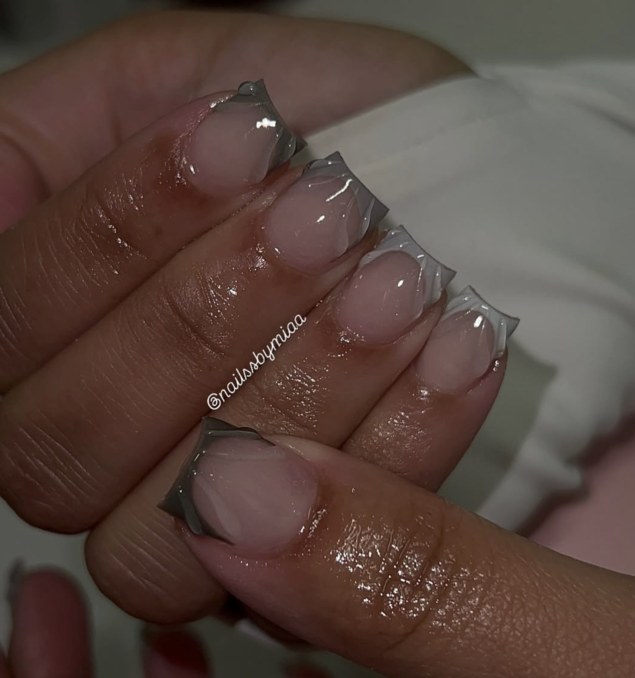 Close-up of mushroom-gray french on neatly manicured hands