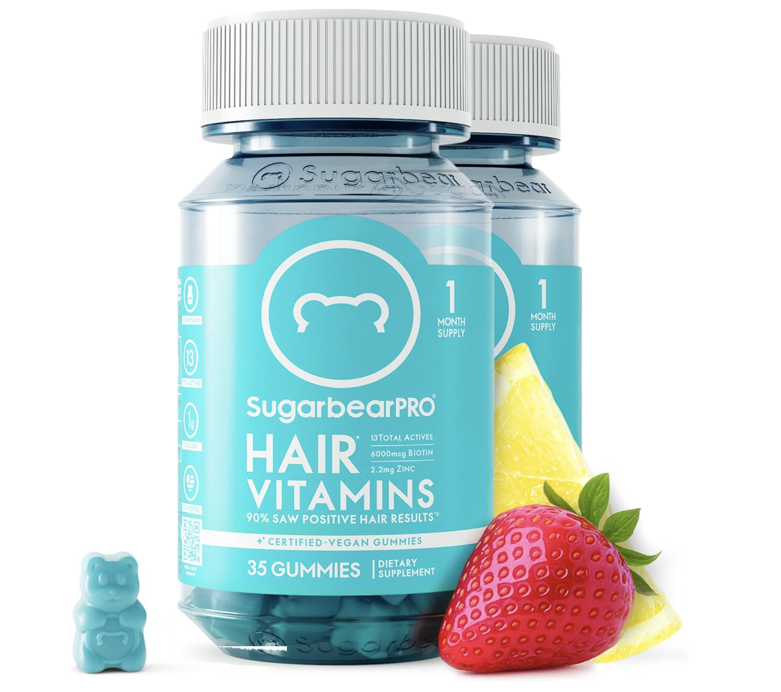A product shot of a blue jar of SugarBearPro Hair Vitamins next to a single blue bear-shaped gummy and a fresh strawberry, highlighting 35 vegan gummies per bottle.