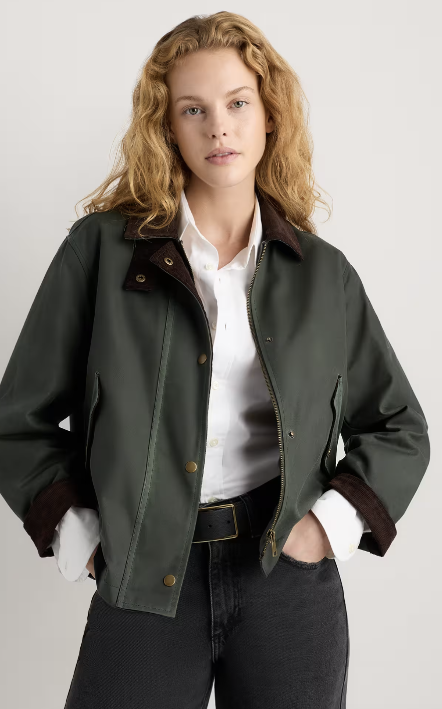 Woman wearing an olive green barn jacket.