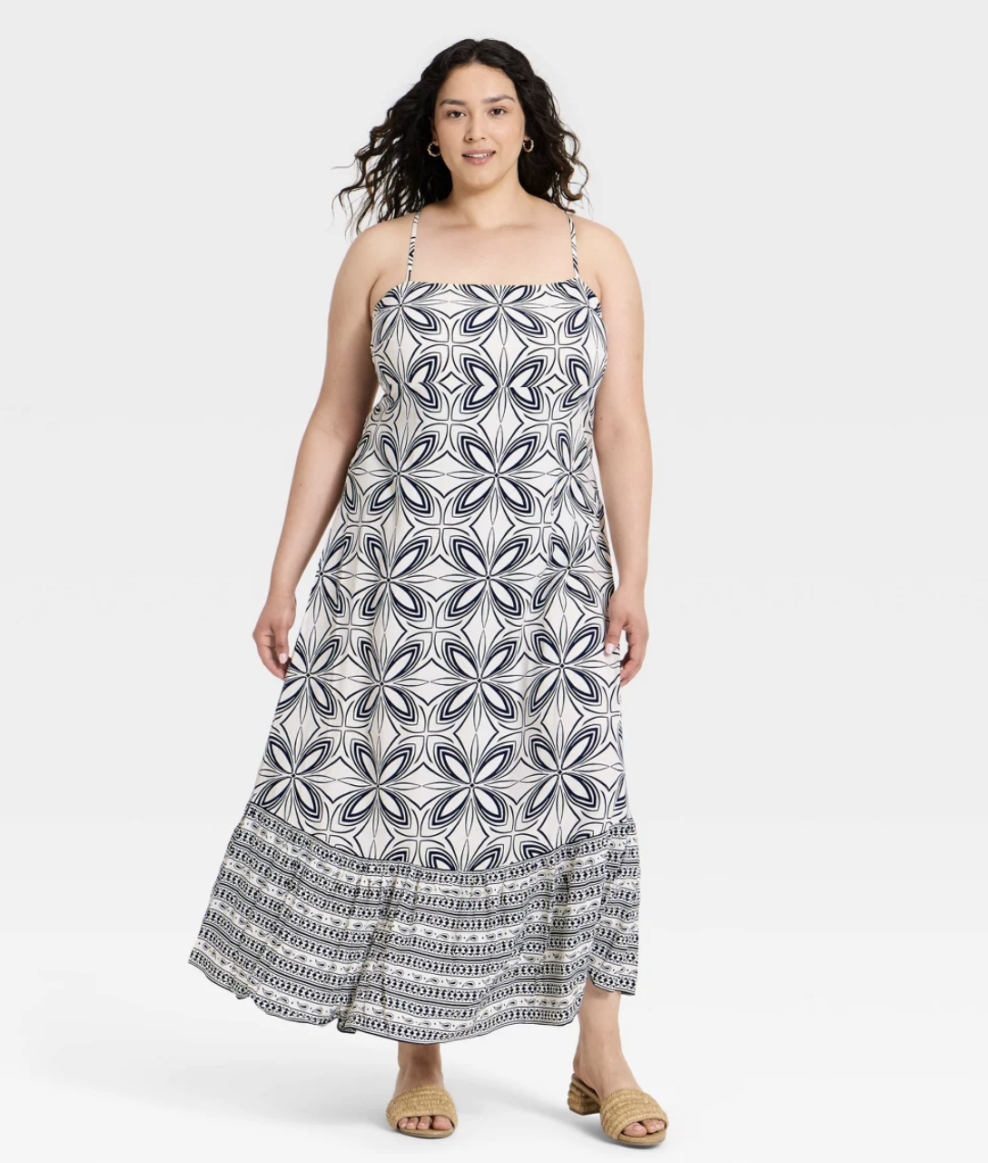 A woman wearing a sleeveless A New Day maxi dress featuring a blue and white medallion print and an open-back design, styled for a summer vacation look.