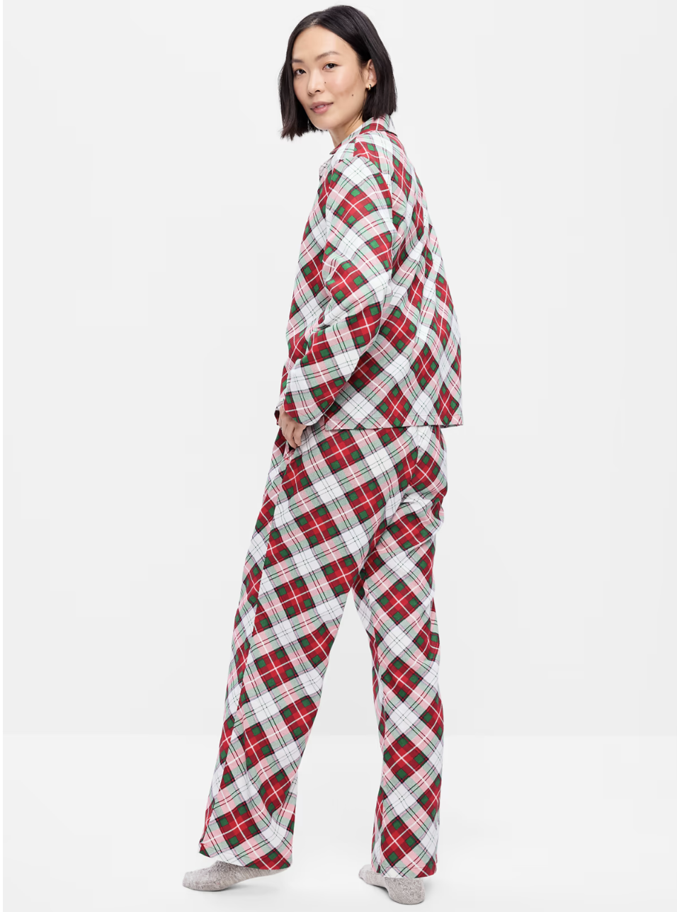 Woman wearing an Old Navy red, green and white plaid flannel pajama set with a collared button-front shirt and full-length pants