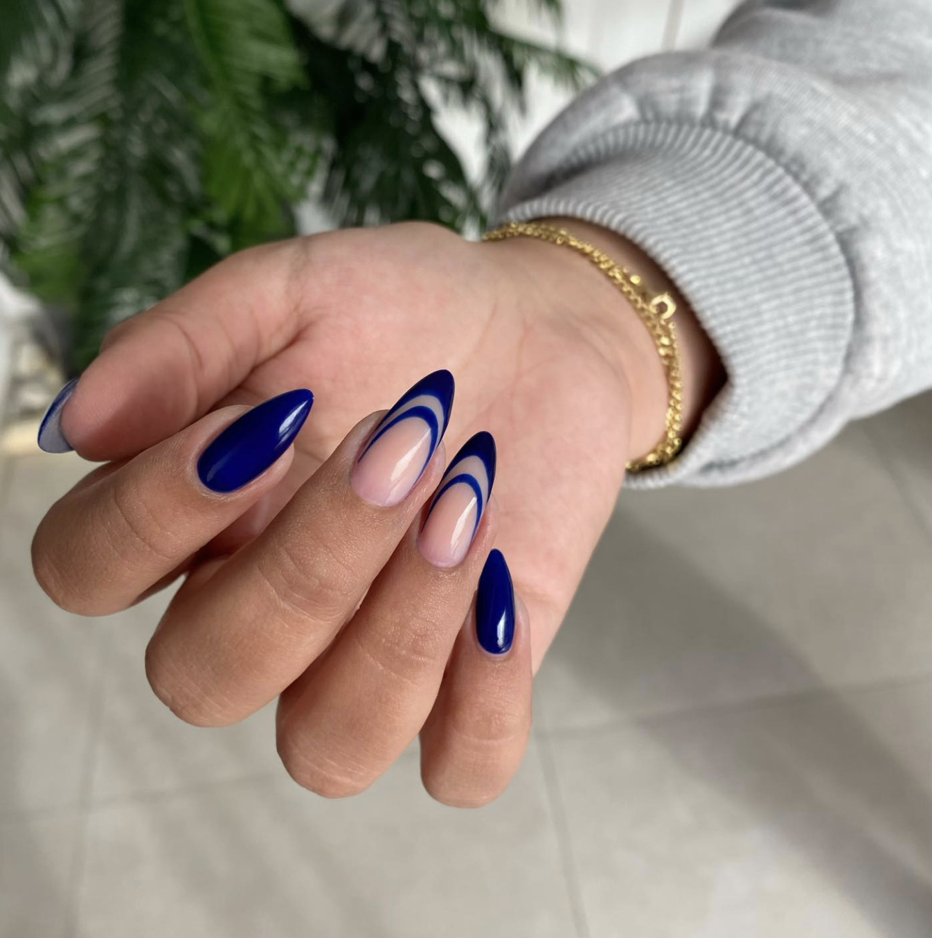 Close-up of navy velvet french on neatly manicured hands