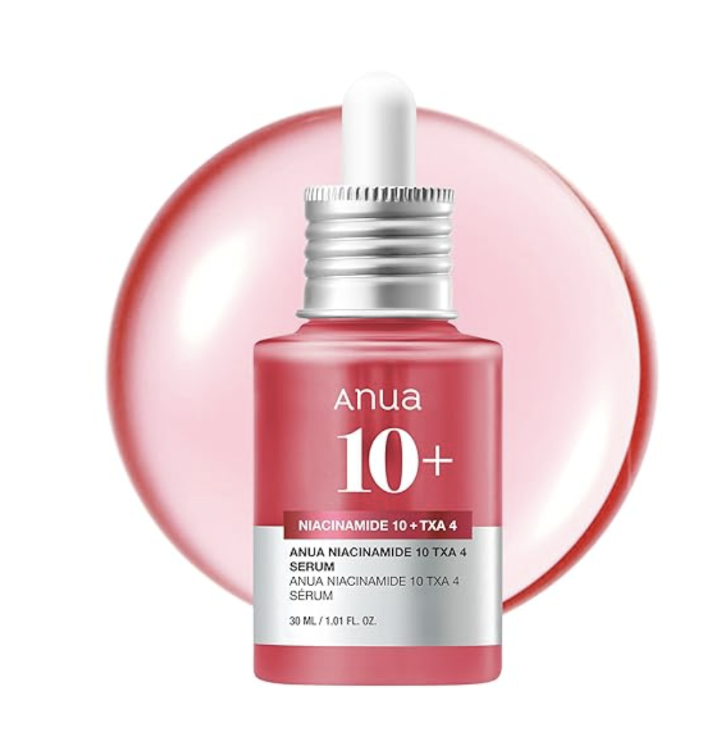 A bottle of Anua Niacinamide 10% and TXA 4% Dark Spot Correcting Serum with a dropper top, set against a soft pink circular background.