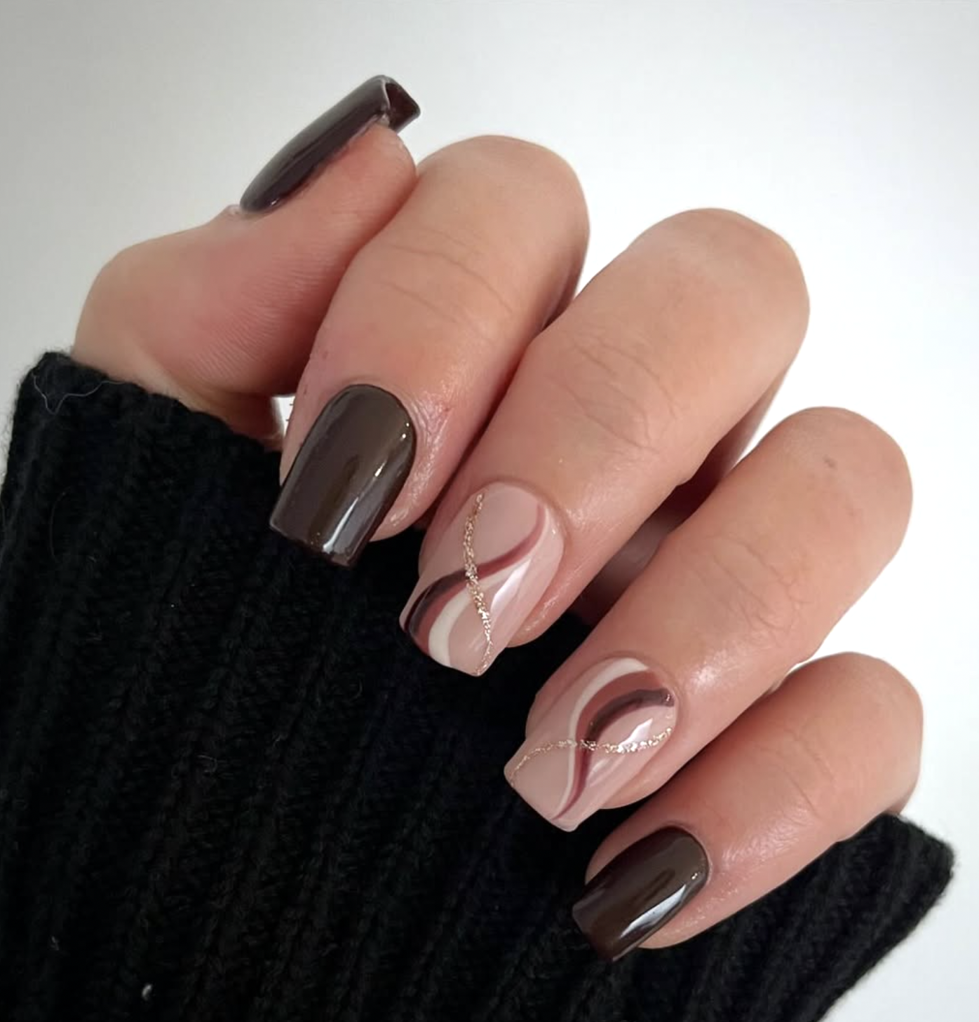 Cream nails with chocolate and caramel swirl nail art