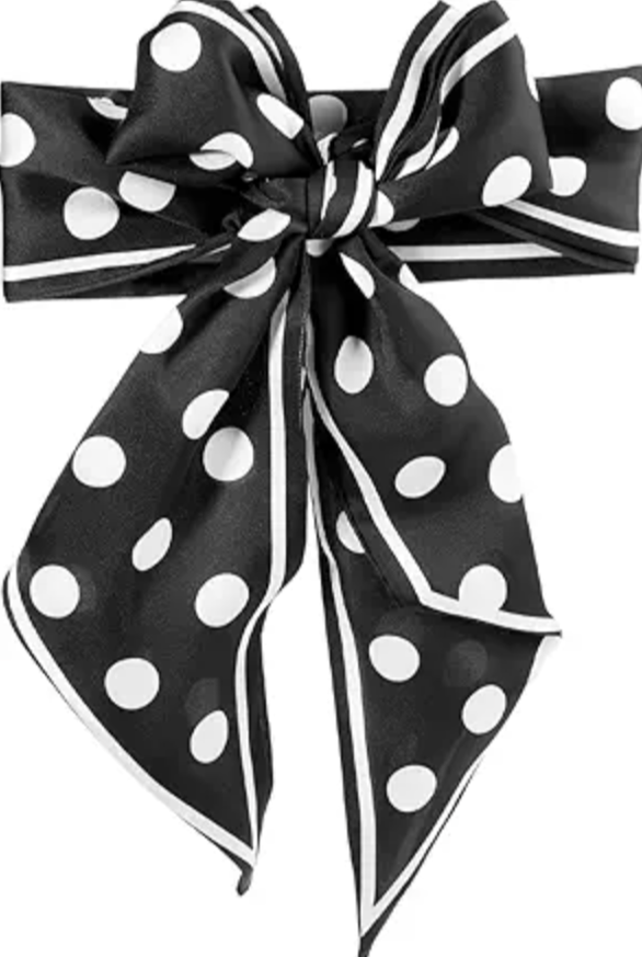 A close-up of a black silk-style neck scarf featuring white polka dots and a striped border, tied into a decorative bow with long cascading ends, shown on a white background.