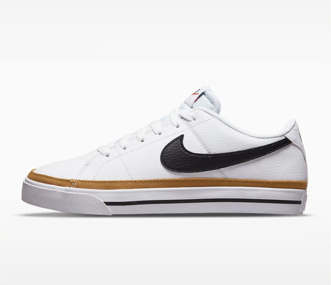A studio product shot of the Nike Court Legacy Next Nature sneaker in white with a black Nike swoosh and a tan gum sole detail.