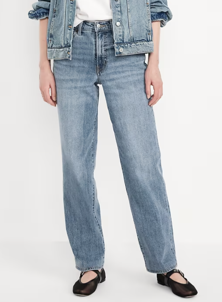 A woman wearing light-wash Old Navy High-Waisted OG Loose Jeans styled with black Mary Jane flats. These 90s-inspired relaxed fit jeans provide a comfortable, baggy silhouette with a smoothing high-rise waist.