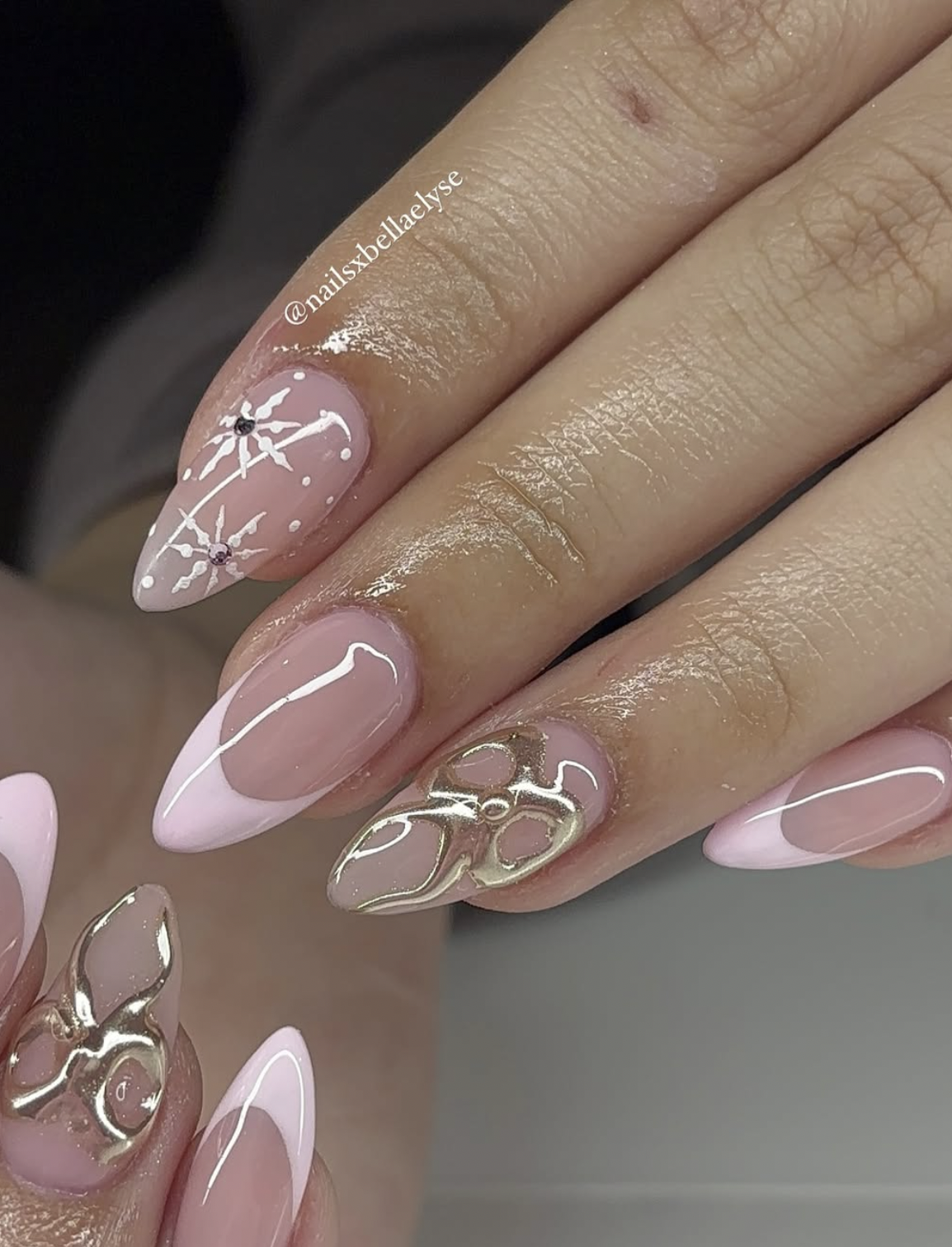 Neutral Christmas nails with metallic gold ribbon and bow nail art