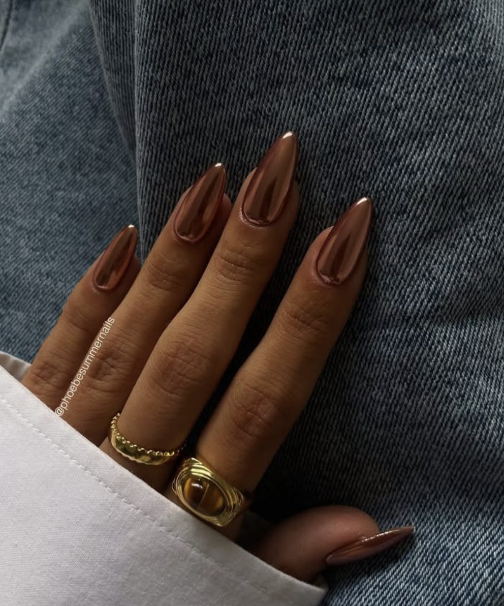 Burnt-orange pumpkin-spice nails with a reflective copper chrome finish